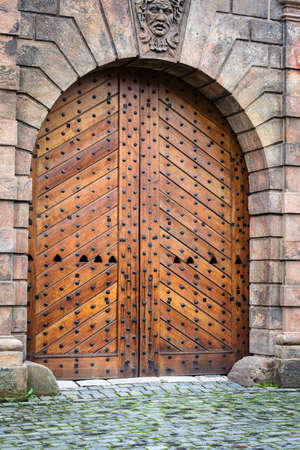 antique wooden gates in the old wallのeditorial素材