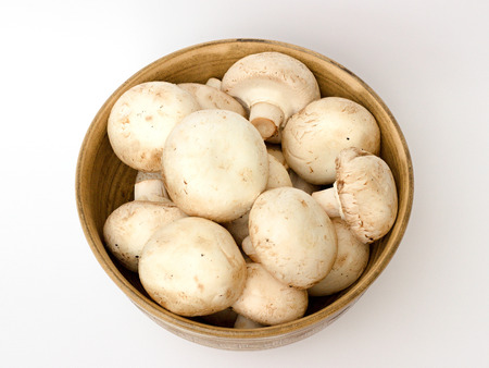 mushrooms in a bowl on a white backgroundの写真素材
