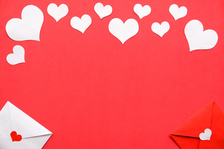 Background for Valentines day. White and rat envelopes, white hearts on a red backgroundの写真素材