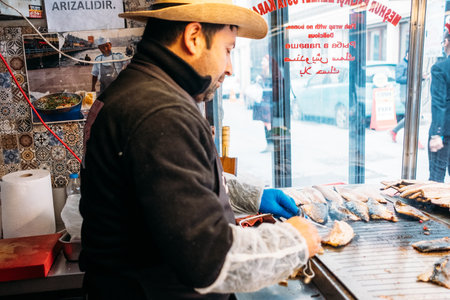 TURKEY, ISTANBUL, DECEMBER 14, 2018: Chef prepares fish in pita bread, Balik Durumのeditorial素材