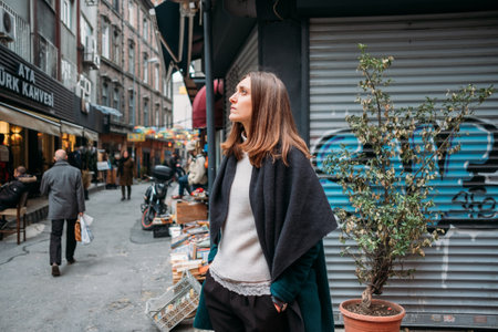 TURKEY, ISTANBUL, DECEMBER 14, 2018: Lonely beautiful girl in a coat on the street of Istanbulのeditorial素材