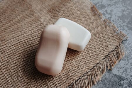 two pieces of natural soap on a rough burlapの写真素材