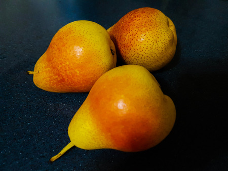 Isolated image of healthy red blush pear fruits with dark background.の写真素材