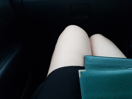 Foreground view of traveler/ tourist  with passports on her laptop with black backgroundの写真素材