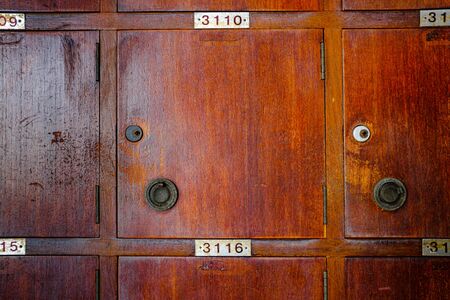 Old cherry wood locker in grungy retro looks.の写真素材