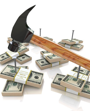 Hammering nails into dollarsの写真素材