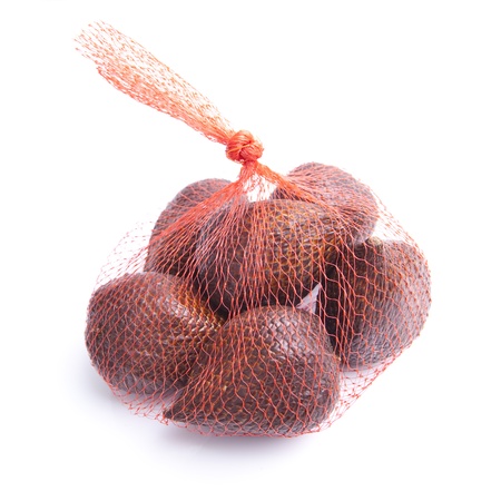 A few snake fruits packed in a mesh netの写真素材