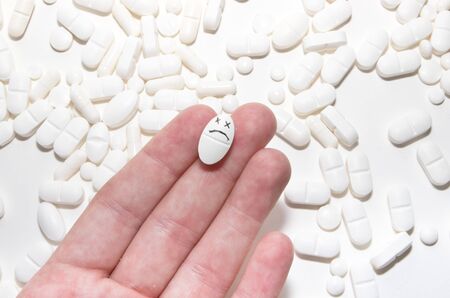 white pills and hand