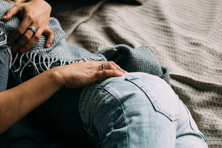 cropped view of couple embracing and relaxing on bed at home. Vintage look.の写真素材
