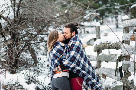 Outdoor fashion portrait of young sensual couple in cold winter weather. love and kissの写真素材