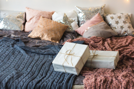 Xmas in morning bedroom. Double bed In christmas Interior on white wall background with cozy lights.の写真素材