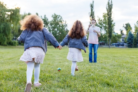 Children with parents in the park. Happy family concept