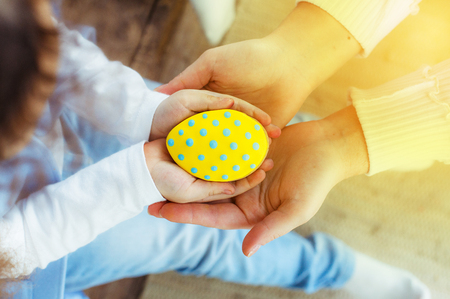 Colorful easter cookies in kids hands. Holiday Easterの写真素材