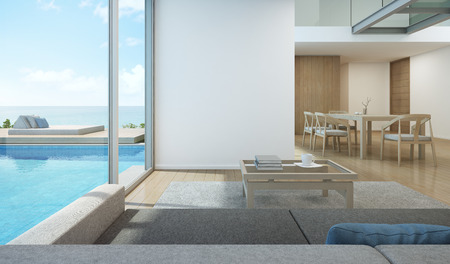 Sea view living room and dining room in modern pool house - 3D renderingの写真素材