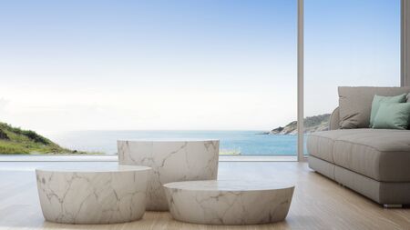 Sea view living room of luxury summer beach house with sofa and coffee table. Empty white marble podiums in studio or showroom. Hotel interior 3d illustration.の写真素材
