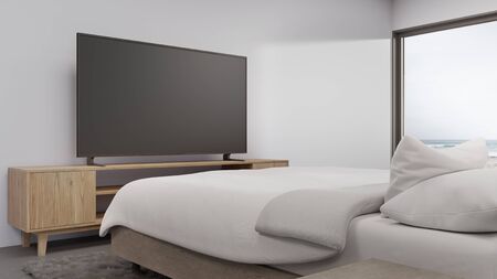 Sea view bedroom of luxury summer beach house with television on TV stand and cabinet near bed. Empty white concrete wall background in vacation home or holiday villa. Hotel interior 3d illustration.の写真素材