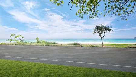 Asphalt road floor and big garden with sea view. 3d illustration of empty green grass lawn.の写真素材