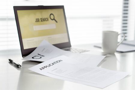 Job seeking in home office. Laptop with online search engine for work. Curriculum vitae or CV and...