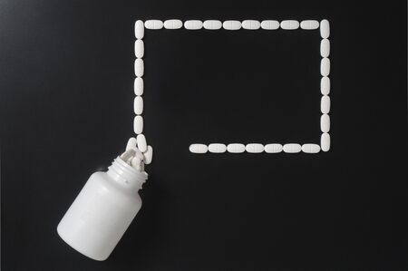 Medical presentation background with a lot a free empty copy space for your text. Pills spilling out from bottle and forming a rectangle. Innovative and different wallpaper for medical infographic.の写真素材