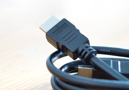 HDMI cable on wooden table at home.の写真素材
