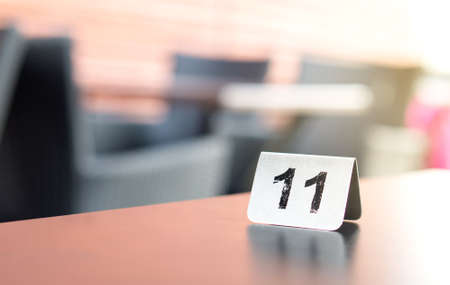 Number sign on restaurant table in outdoor terrace to show reservation. Customer waiting for service or food.の写真素材