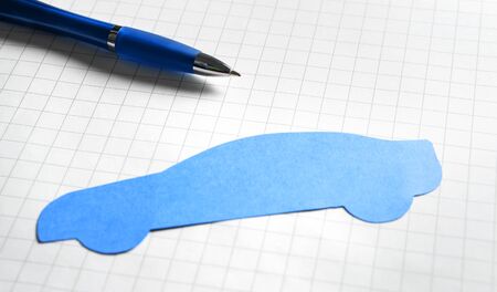 Car sale or loan, auto insurance or vehicle inspection and check up concept. Buying new or used automobile. Written exam or test at driving school. Cardboard paper shape with pen.の写真素材