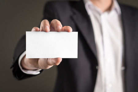 Business man holding empty white business card.の写真素材