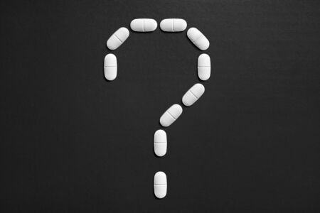Question mark made from pills. New idea or innovation in science or pharmaceutical industry. Wondering medical issues.の写真素材