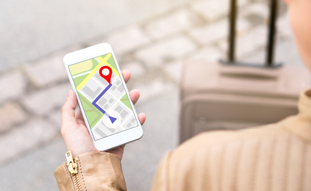 Woman navigating with mobile phone map application. Tourist with walking route on smartphone screen....