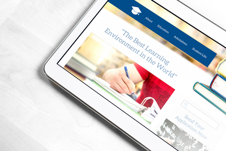 School website homepage design on tablet screen. College application or applying for University concept. Searching information about education and institutions.の写真素材