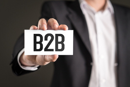 B2B and business-to-business marketing concept. Businessman holding card with text.の写真素材