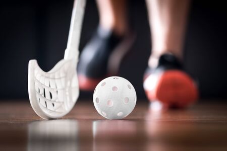 Floorball player running with ball and stick. Floor hockey concept.