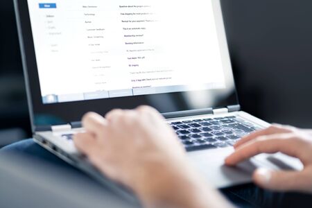 Email inbox full of messages and text. Man reading electronic mail with laptop. Spam, junk and e...