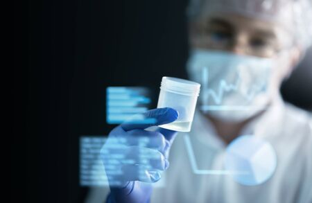 Scientist in laboratory doing medical research with future health care technology. AR screen and...