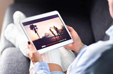 Streaming movie with VOD service. Woman watching online tv series stream. Video on demand app in...