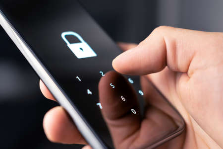 Mobile phone security code, password or lock for personal online privacy and verification. 2FA (two factor authentication) and passcode for data and identity protection. Cyber hacker, fraud or threat.の写真素材
