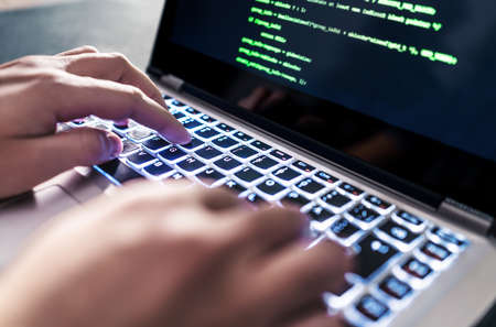 Hacker code in laptop. Cyber security, privacy or hack threat. Coder or programmer writing virus...