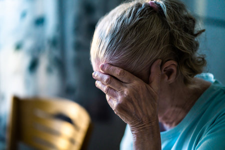 Sad senior old woman. Lonely from loss or sick with headache. Upset patient in retirement home with stress or pain. Alzheimer, depression, senility or dementia. Disorder, migraine or insomnia.の写真素材