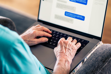 Old woman and online romance scam. Love and money fraud on internet. Elder senior using computer. Fake profile and catfish on dating website chat messages. Instant messaging. Mature person with laptopの写真素材