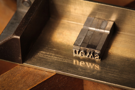Composing stick with the letters \"news\"の写真素材