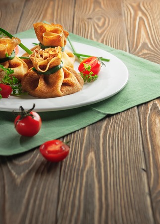 Pancakes with meat, tied with green onionsの写真素材