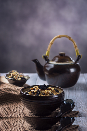 Oatmeal porridge with walnuts and raisinsの写真素材