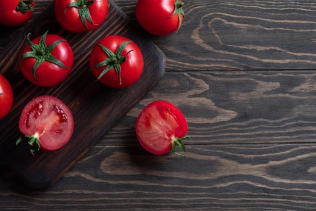 Fresh red tomatoes on a wooden board
