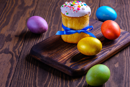 Festive food. Easter cakes and colored eggs on a wooden table