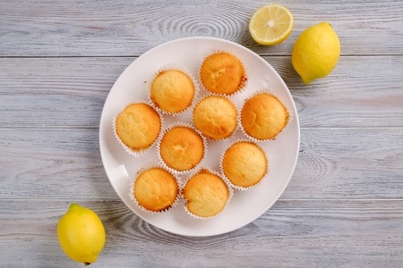 Fresh lemon and lemon muffin on a wooden tableの写真素材