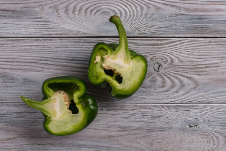 Healthy food. Green pepper cut in half close up on a wooden table.の写真素材
