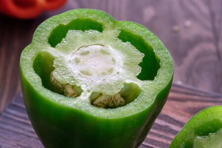 Fresh sweet red and green peppers on a wooden tableの写真素材