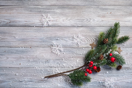 Green branch of christmas tree decorated with christmas decor on wooden tableの写真素材
