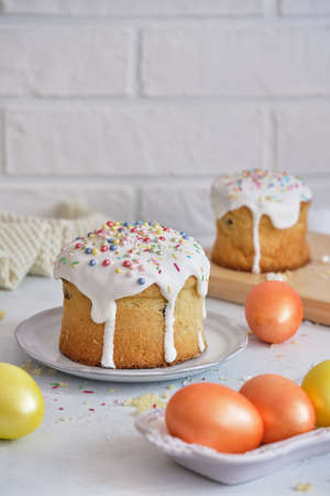 EasterFestive food. Easter cakes and colored eggs on a white table