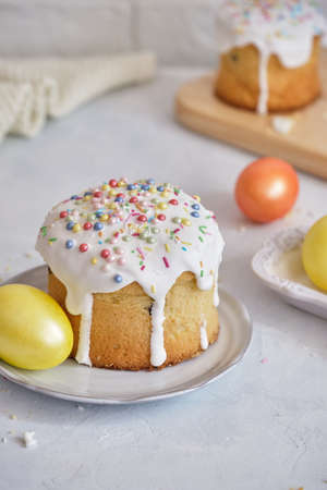 EasterFestive food. Easter cakes and colored eggs on a white table